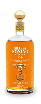 Grappa Nonino Riserva bottle with a glass of grappa on a white background