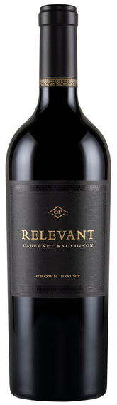 A bottle of Relevant Cabernet Sauvignon from Crown Point, featuring a dark black glass bottle with a black label and gold lettering.