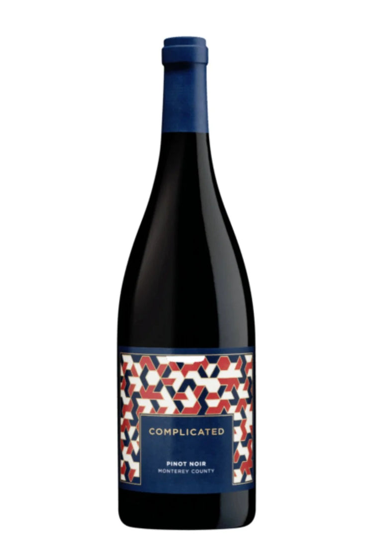A bottle of Complicated Pinot Noir from Monterey County, featuring a dark glass body, a blue foil capsule at the top, and a colorful geometric patterned label with red, white, and blue shapes.