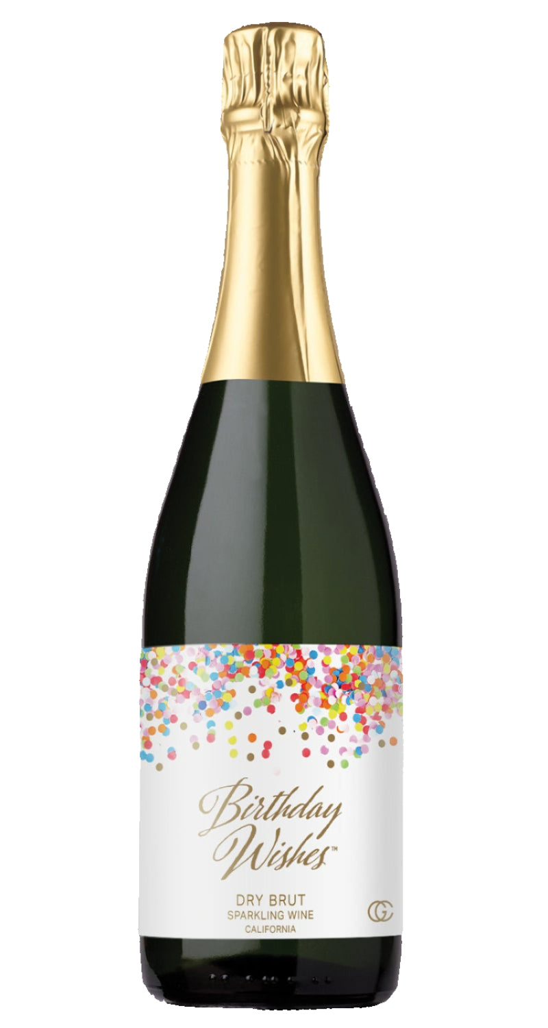 Bottle of 'Birthday Wishes' sparkling wine with a glass of champagne on a white background
