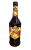 Bottle of Tierra del Sol Root Beer on a desk with a computer and mouse.