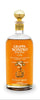 Grappa Nonino Riserva bottle with a glass of grappa on a white background