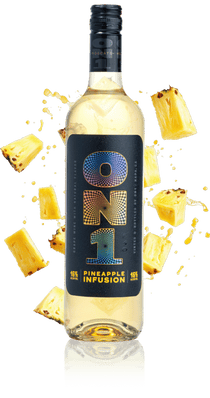 Bottle of ON1 Pineapple Infusion with pineapple pieces on a beige background