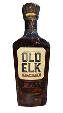 Bottle of Old Elk whiskey on a dark surface with blurred background