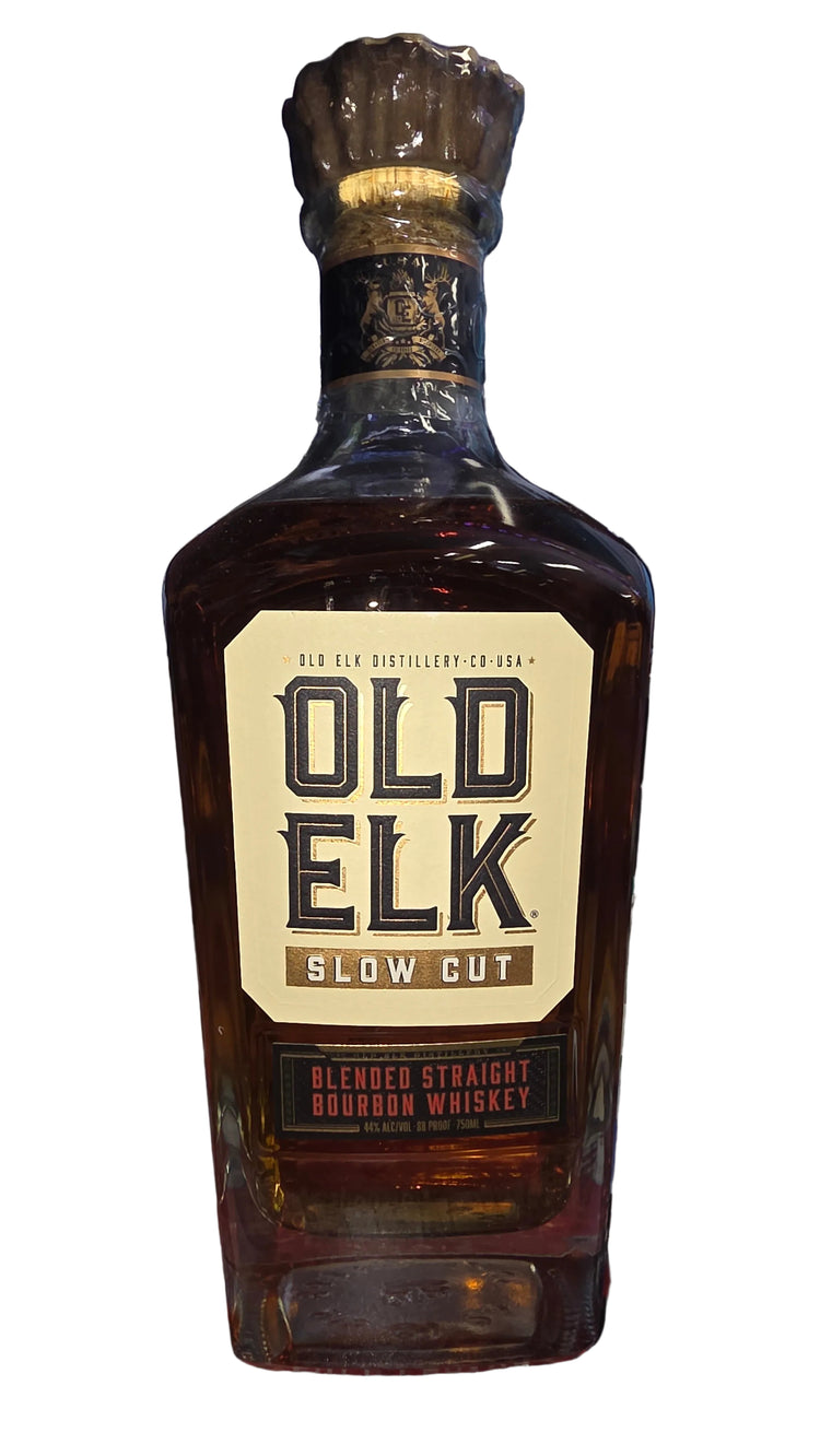 Bottle of Old Elk whiskey on a dark surface with blurred background