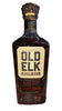 Bottle of Old Elk whiskey on a dark surface with blurred background