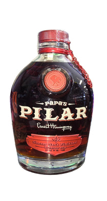 Bottle of Papa's Pilar rum with a dog in the background