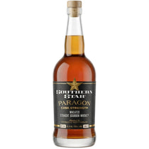 A bottle of Southern Star Paragon Cask Strength wheated straight bourbon whiskey, featuring an amber-brown liquid, a black label with gold lettering, and a cork stopper, set against a plain white background.