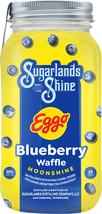 Mason jar of Sugarlands Shine Eggo Blueberry Waffle Moonshine with blueberries on a yellow background