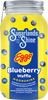 Mason jar of Sugarlands Shine Eggo Blueberry Waffle Moonshine with blueberries on a yellow background