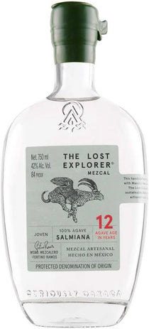 A clear glass bottle of Tequila by Seriously Garza, featuring a dark green cap and a light gray-green label with a black rooster illustration and red text indicating 12 years of age. The brand 'Seriously Garza' is embossed at the bottom of the bottle.