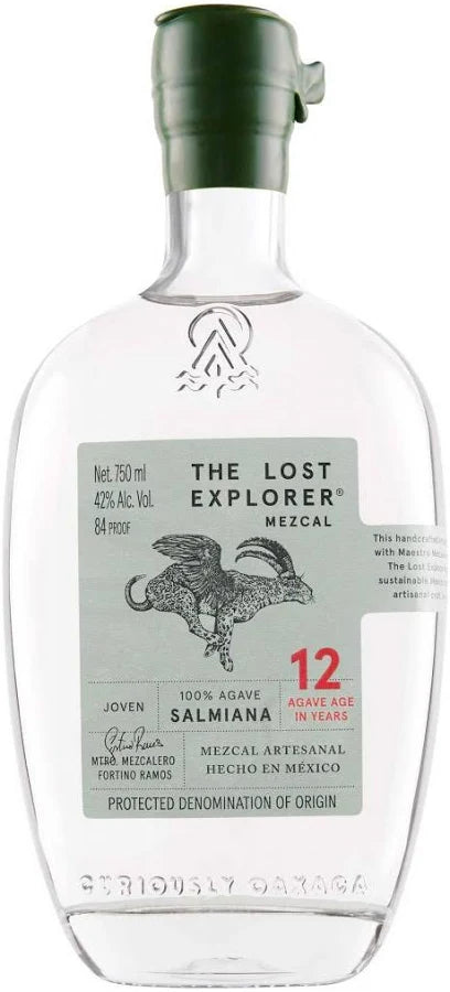 A clear glass bottle of Tequila by Seriously Garza, featuring a dark green cap and a light gray-green label with a black rooster illustration and red text indicating 12 years of age. The brand 'Seriously Garza' is embossed at the bottom of the bottle.