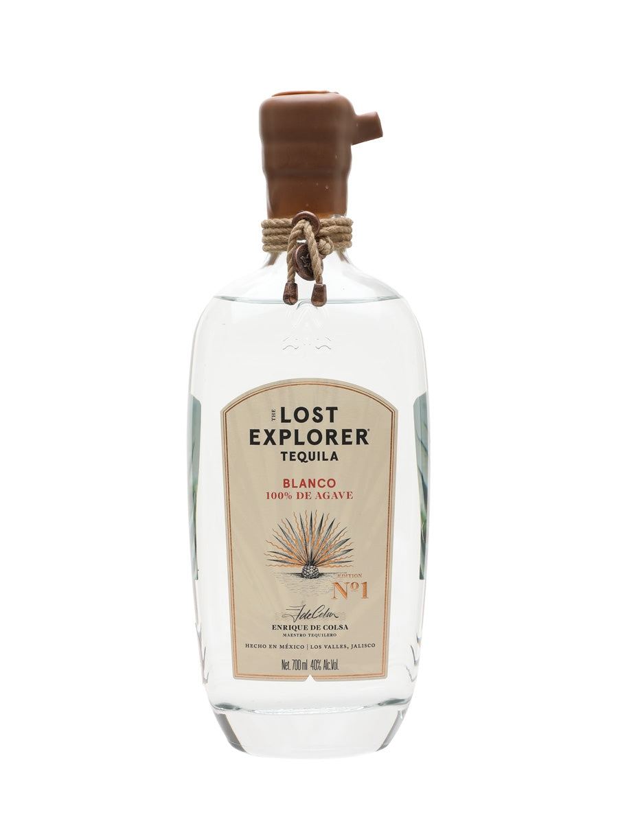 A bottle of Lost Explorer Tequila Blanco 100% de Agave, featuring a clear glass bottle with a brown wooden stopper and a beige label, set against a plain white background.