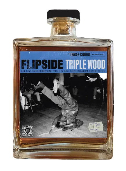 Bottle of Flipside Triple Wood with a black and white photo of a handstand on the label.