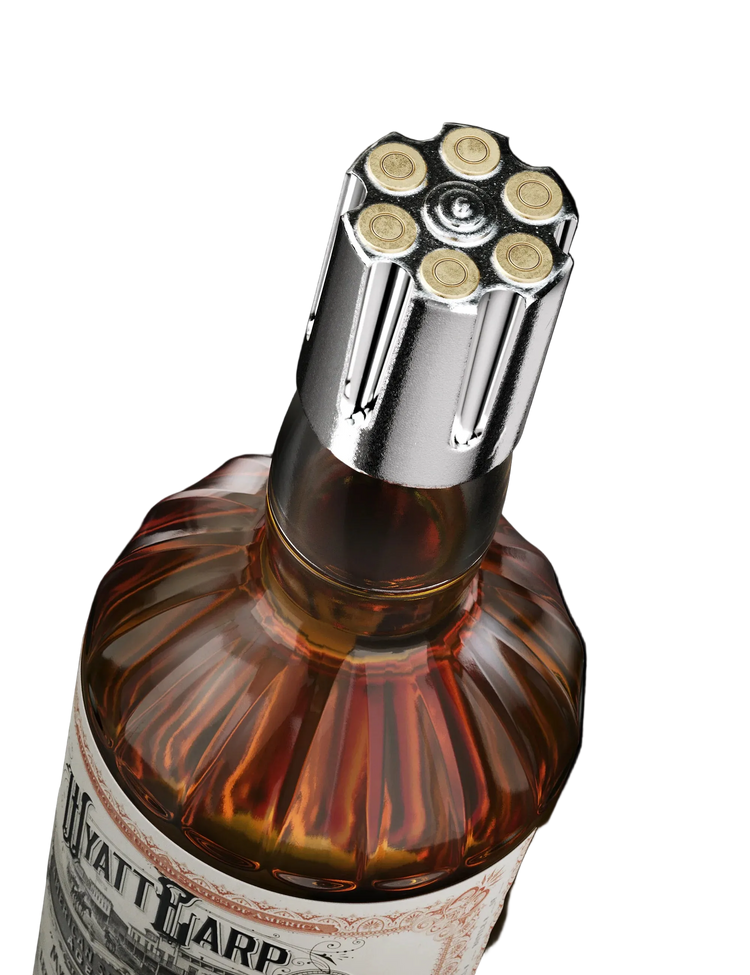 Bottle of Wyatt Earp whiskey with a unique bottle cap design on a black background