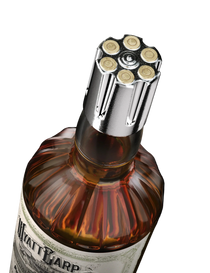Bottle cap with bullet design on a bottle labeled 'Watt & Warp' against a black background